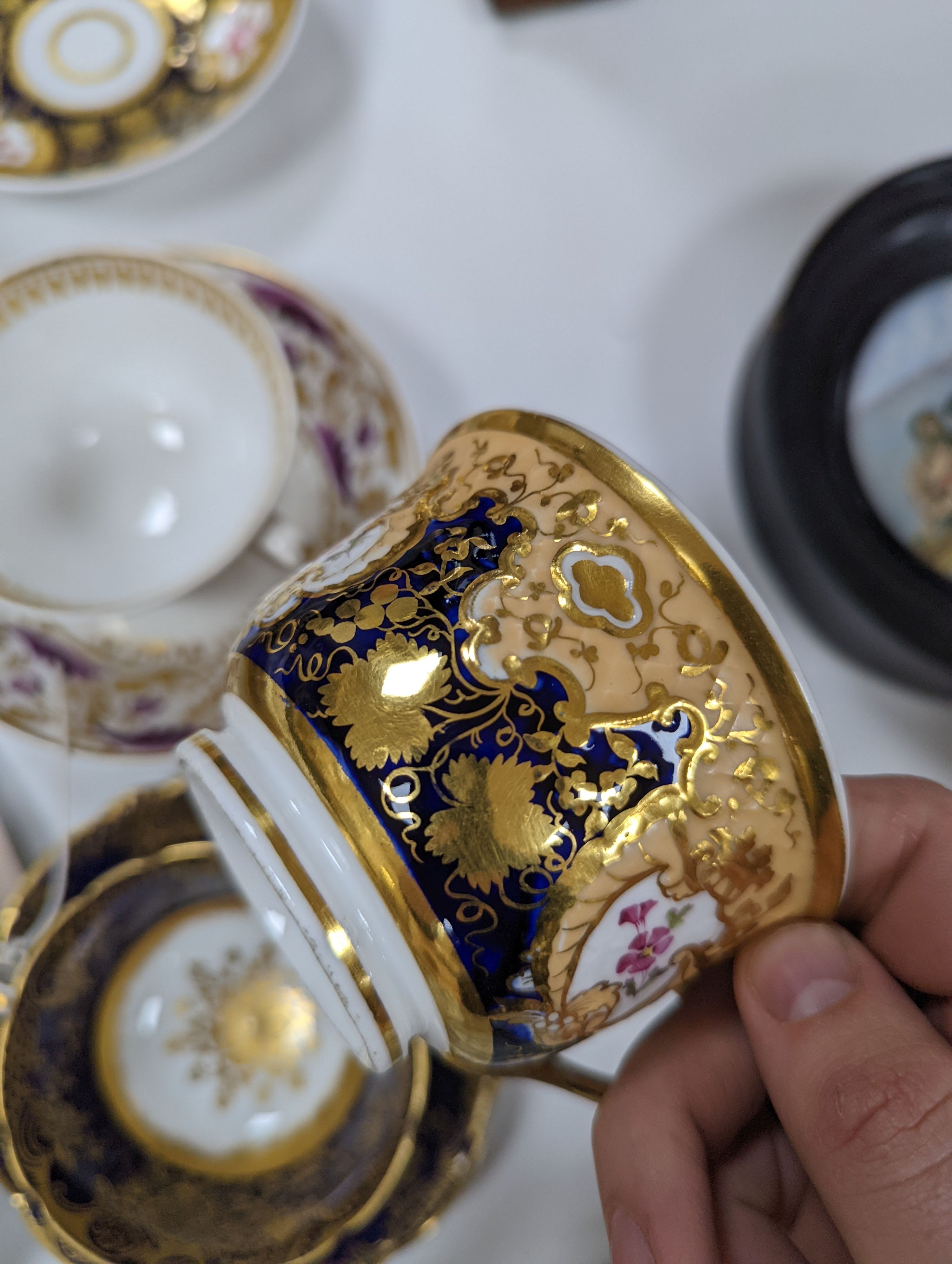 A small collection of Victorian porcelain tea cups and saucers and sundry dessert plates